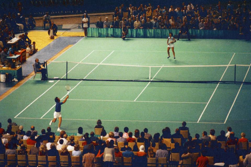 Bobby Riggs and Billie Jean King compete in the "Battle of the Sexes" at the Houston Astrodome.
