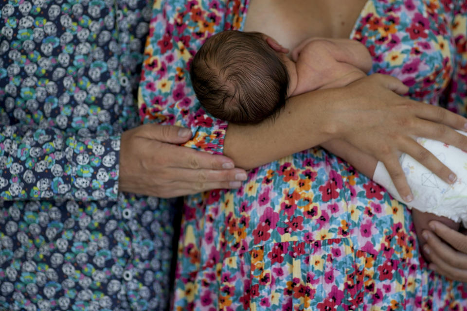 Maxim Levoshin and his wife Ekaterina Gordienko pose for a photo with their newborn baby named Leo in Buenos Aires, Argentina, Saturday, Feb. 18, 2023. The Russian couple arrived in the Argentine capital in December. “The first thing we want is for Leo to live in a safe country, without a war in his future,” Levoshin said. (AP Photo/Natacha Pisarenko)