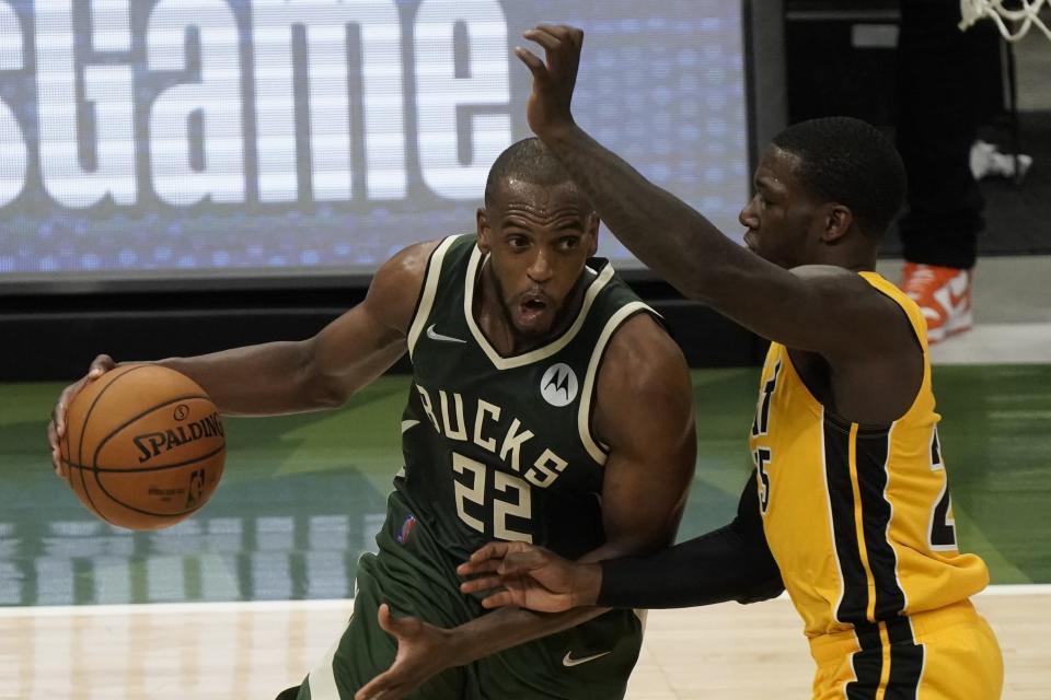 Milwaukee Bucks' Khris Middleton drives past Miami Heat's Kendrick Nunn during the second half of Game 1 of their NBA basketball first-round playoff series Saturday, May 22, 2021, in Milwaukee. (AP Photo/Morry Gash)