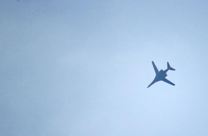 A U.S.-led coalition aircraft flying over Kobanii, as seen near the Mursitpinar border crossing on the Turkish-Syrian border in the southeastern town of Suruc in Sanliurfa province, October 18, 2014. A U.S.-led military coalition has been bombing Islamic State fighters who hold a large swathe of territory in both Iraq and Syria, two countries involved in complex multi-sided civil wars in which nearly every country in the Middle East has a stake.. REUTERS/Kai Pfaffenbach (TURKEY - Tags: MILITARY POLITICS CONFLICT)