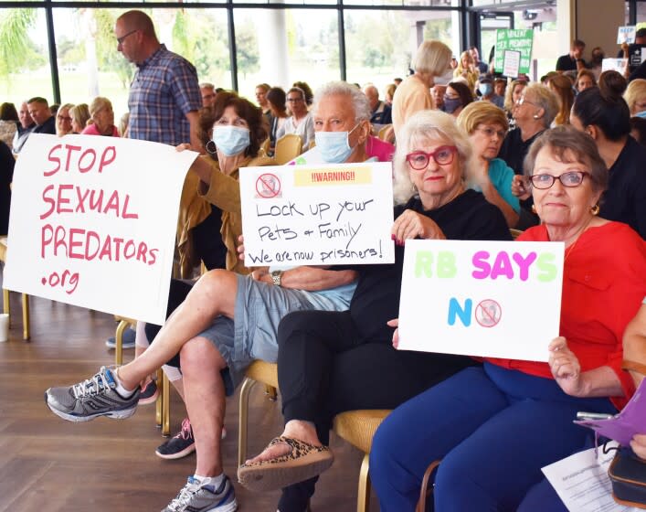 Rancho Bernardo residents held up signs to oppose sexually violent predator Douglas Badger's placement in their community.