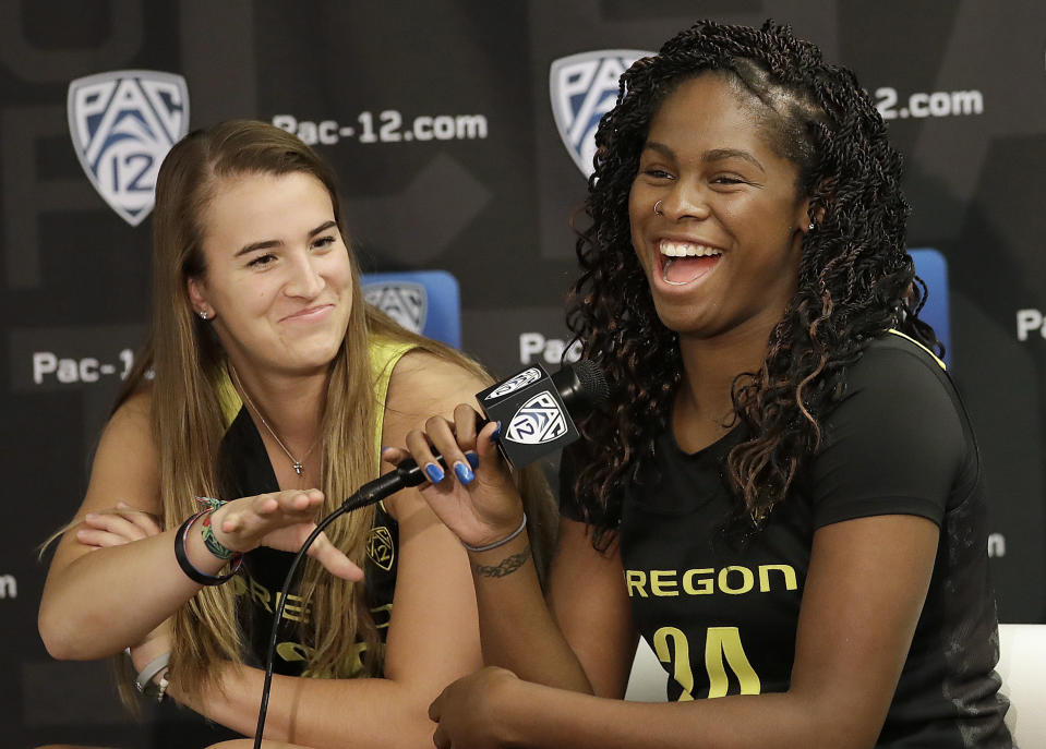 Oregon's Ruthy Hebard, right, speaks next to Sabrina Ionescu during NCAA college basketball Pac-12 media day in San Francisco, Wednesday, Oct. 10, 2018. (AP Photo/Jeff Chiu)