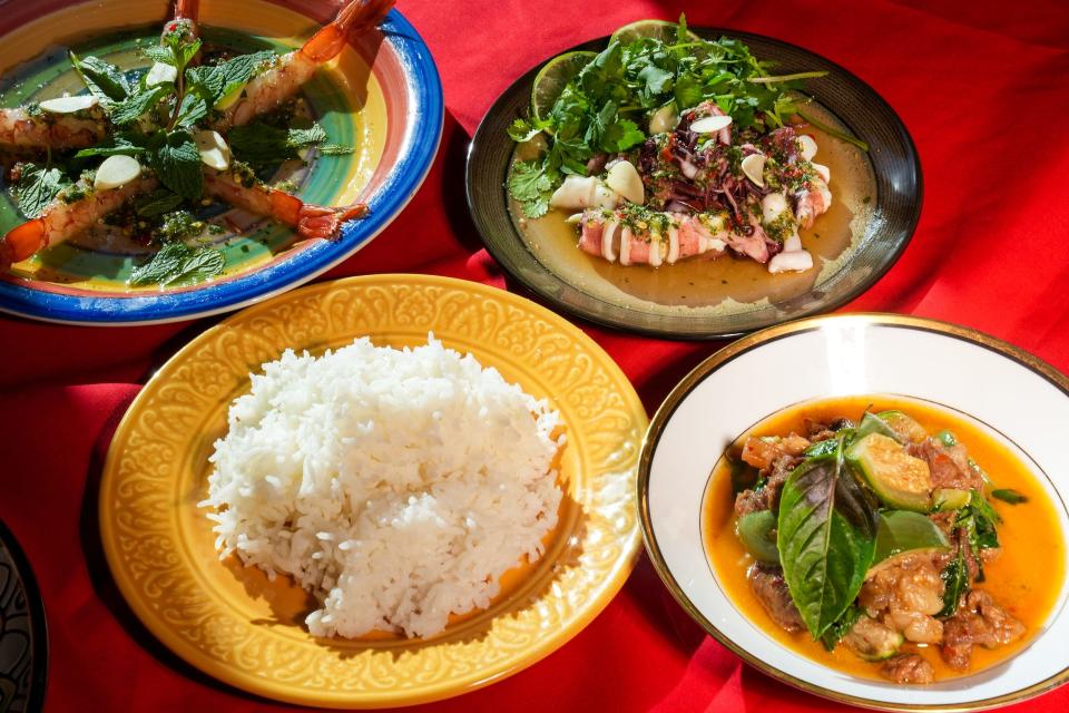Clockwise from top left, Kung Shae Nam Pla (shrimp bathed in fish sauce), Chu Bai Neung Boo Wak Now (steamed squid and squid eggs with chili, lime, and garlic), Kaeng Phed Charinda (red curry with hand-pounded nam prik kaeng phet, hand-squeezed coconut milk, beef, Thai eggplant, Thai basil), and rice at Lom Wong on Thursday, Feb. 17, 2022, in Phoenix.