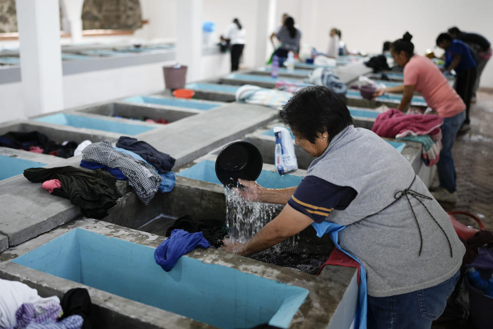 Residents who have run out of water in their homes, hand wash their clothes in pilas or washbasins in an a open-air laundromat, in the Xochimilco neighborhood of Mexico City, Tuesday, April 2, 2024. As the election approaches, a worsening water crisis is making it harder for the presidential candidates to ignore Mexico’s climate threats (AP Photo/Eduardo Verdugo)