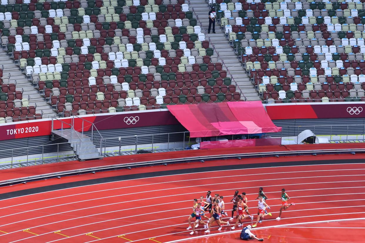 An overview shows empty stadium seats as athletes compete in the men's 1500m heats during the Tokyo 2020 Olympic Games at the Olympic Stadium in Tokyo on August 3, 2021. (Photo by Antonin THUILLIER / AFP) (Photo by ANTONIN THUILLIER/AFP via Getty Images)