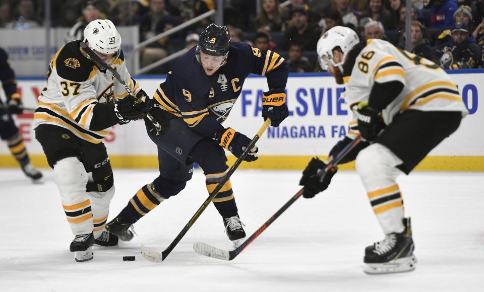 <p>
              Buffalo Sabres center Jack Eichel, center, battles for the puck against Boston Bruins center Patrice Bergeron (37) and defenseman Kevan Miller (86) during the second period of an NHL hockey game in Buffalo, N.Y., Saturday, Dec. 29, 2018. (AP Photo/Adrian Kraus)
            </p>