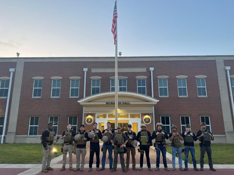 The Marine Security Guard Detachment assigned to the US Embassy in Khartoum, Sudan, stand for a photo in front of McMaugh Hall at Marine Corps Embassy Security Group Headquarters, Quantico, Va., on April 24.