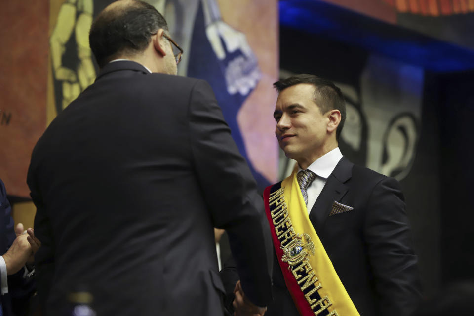 National Assembly President Henry Kronfle shakes hands with newly sworn-in President Daniel Noboa during his inauguration ceremony at the National Assembly, in Quito, Ecuador, Thursday, Nov. 23, 2023. (AP Photo/Juan Diego Montenegro)