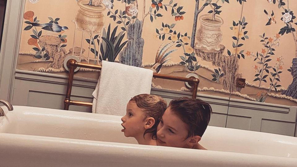 jamies kids in bath in room with maximalist wallpaper 