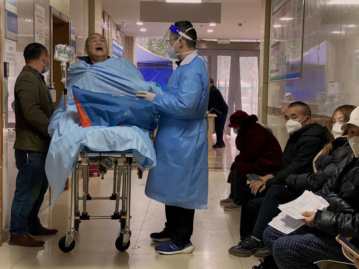 An elderly covid-19 patient lies on a stretcher at the emergency ward of the First Affiliated Hospital of Chongqing Medical University in China's southwestern city of Chongqing on December 22, 2022.
