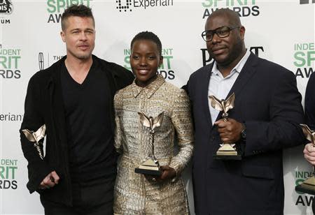 Producer Brad Pitt, actress Lupita Nyong'o and director Steve McQueen pose with their awards for "12 Years a Slave" backstage at the 2014 Film Independent Spirit Awards in Santa Monica, California March 1, 2014. REUTERS/Danny Moloshok