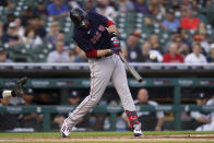 Boston Red Sox's J.D. Martinez hits a one-run single against the Detroit Tigers in the first inning of a baseball game in Detroit, Tuesday, Aug. 3, 2021. (AP Photo/Paul Sancya)