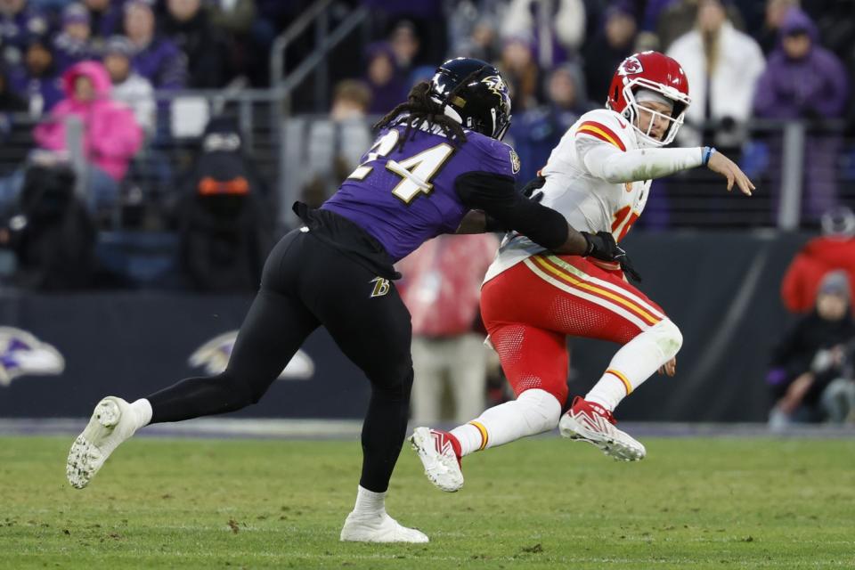 Jan 28, 2024; Baltimore, Maryland, USA; Kansas City Chiefs quarterback Patrick Mahomes (15) is knocked down after passing the ball by Baltimore Ravens linebacker Jadeveon Clowney (24) in the AFC Championship football game at M&T Bank Stadium. Mandatory Credit: Geoff Burke-USA TODAY Sports