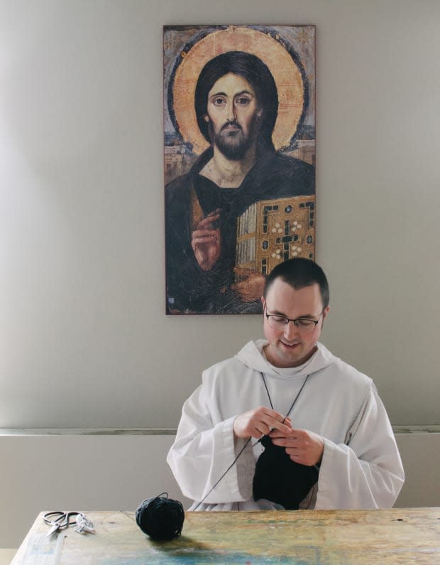 Brother Aidan knitting in his studio. Photo: Whitney Bauck/Fashionista