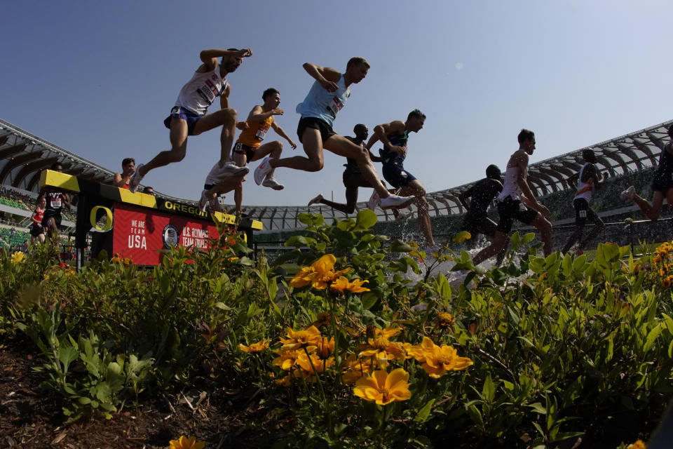 Runners compete during first heat of the men's 3000-meter steeplechase at the U.S. Olympic Track and Field Trials Monday, June 21, 2021, in Eugene, Ore. (AP Photo/Charlie Riedel)