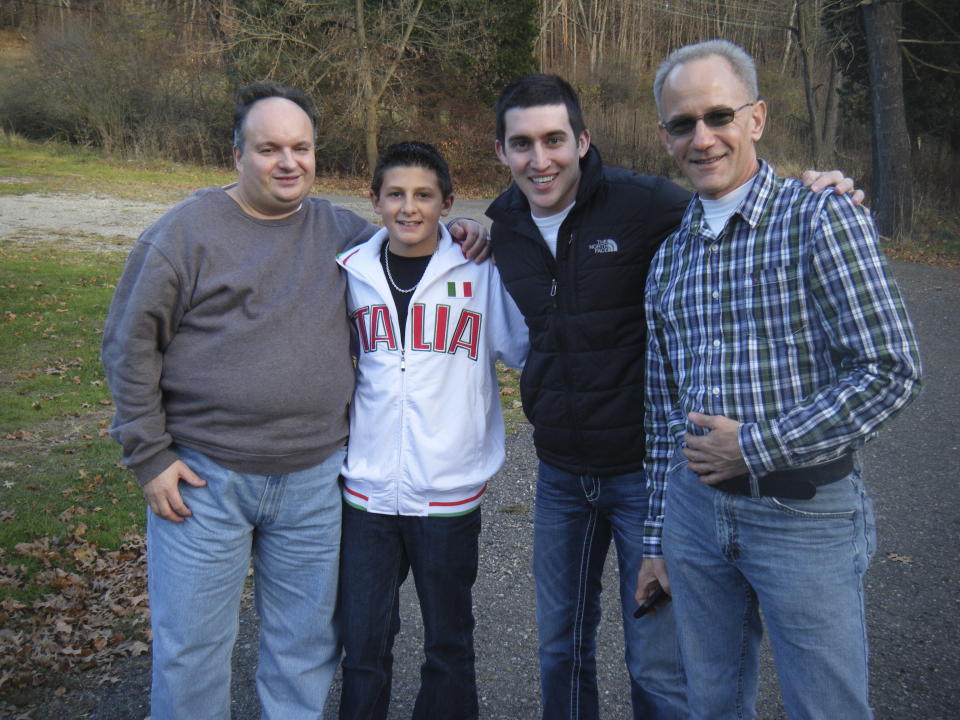This 2014 photo provided by the family shows Anthony Talotta, left, posing for a picture with family during a visit in Pittsburgh. Talotta's family was working with attorneys to get the 57-year-old autistic man out of the Allegheny County Jail, where he had been taken on September 10, 2022 after a physical altercation with a staff member at the group home where he lived. But 11 days after he arrived at the jail, Talotta died from what his family says was a treatable and preventable infection from a wound he had received during the altercation at the group home. (Courtesy of Family via AP)