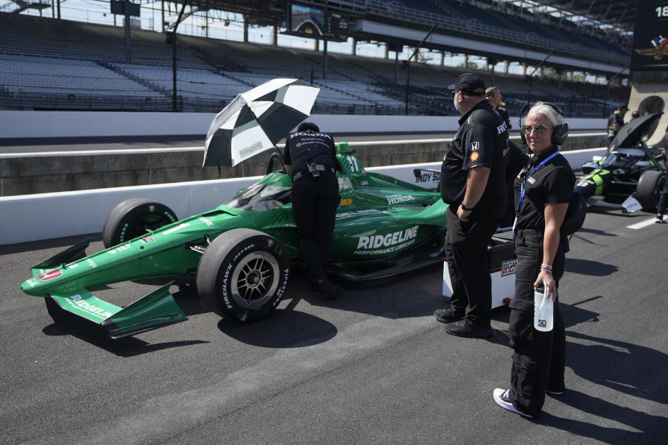 Angela Cullen, right, stands near the car of Marcus Armstrong, of New Zealand, on pit lane during qualifications for the Indianapolis 500 auto race at Indianapolis Motor Speedway, Saturday, May 18, 2024, in Indianapolis. Cullen is the former trainer for Lewis Hamilton. AP Photo/Darron Cummings)