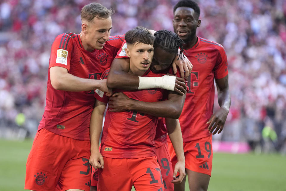 Bayern's Bryan Zaragoza, centre, celebrates with teammates a goal that was later disallowed by a VAR decision during the German Bundesliga soccer match between Bayern Munich and VfL Wolfsburg at the Allianz Arena in Munich, Germany, Sunday, May 12, 2024. (AP Photo/Matthias Schrader)