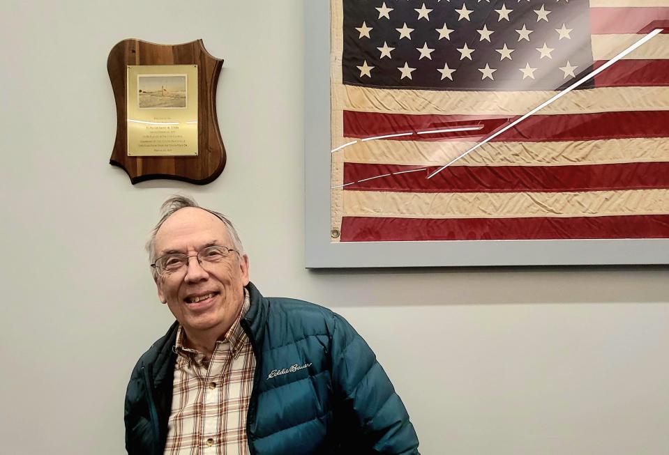Marysville native Gary Brougham appears with a flag once flown at the South Pole on Monday, March 25, 2024. Brougham, who'd been stationed at Amundsen-Scott South Pole Station to study geophysics for 15 months in the early 1970s, said the flag had special meaning to him for both his family's history in the city of Marysville and the teamwork and resilience it symbolized.