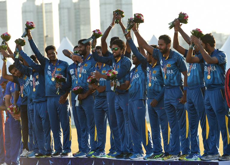 Sri Lanka's team celebrate on the podium with their gold medals after beating Afghanistan in the Asian Games cricket final in Incheon on October 3, 2014
