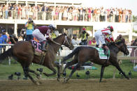 Jose Ortiz, right, atop Early Voting wins the 147th running of the Preakness Stakes horse race in front of Joel Rosario, left, atop Epicenter, at Pimlico Race Course, Saturday, May 21, 2022, in Baltimore. (AP Photo/Julio Cortez)