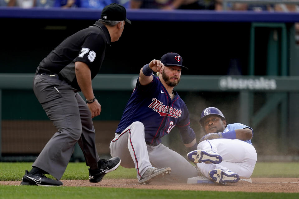 Kansas City Royals' Jarrod Dyson beats the tag by Minnesota Twins third baseman Josh Donaldson to advance to third on a ground out hit into by Jorge Soler during the ninth inning of a baseball game Saturday, June 5, 2021, in Kansas City, Mo. The Twins won 5-4. (AP Photo/Charlie Riedel)