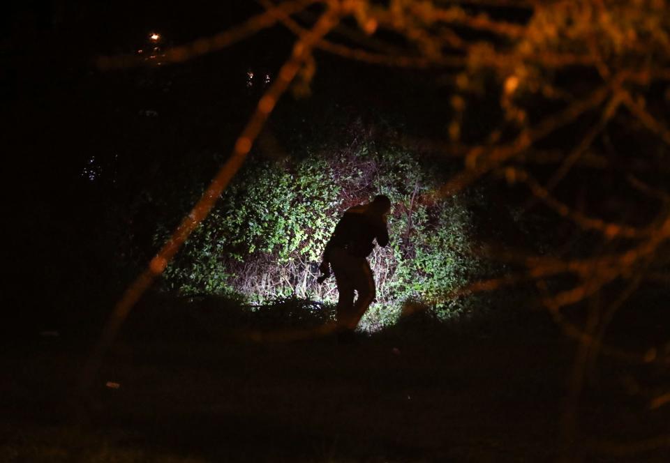 New Castle County Police investigate a wooded area adjacent to where a shooting took place on N. Rodney Drive in Edgemoor Gardens, reported about 12:30 a.m. Thursday, March 28, 2024.