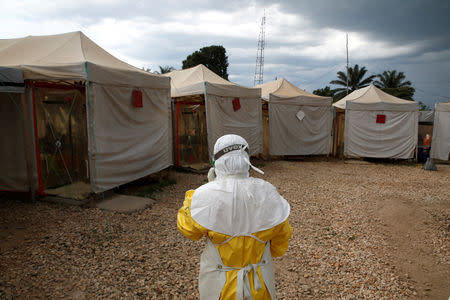 FILE PHOTO: A health worker wearing Ebola protection gear, walks before entering the Biosecure Emergency Care Unit (CUBE) at the ALIMA (The Alliance for International Medical Action) Ebola treatment centre in Beni, in the Democratic Republic of Congo, March 30, 2019. Picture taken March 30, 2019.REUTERS/Baz Ratner/File Photo