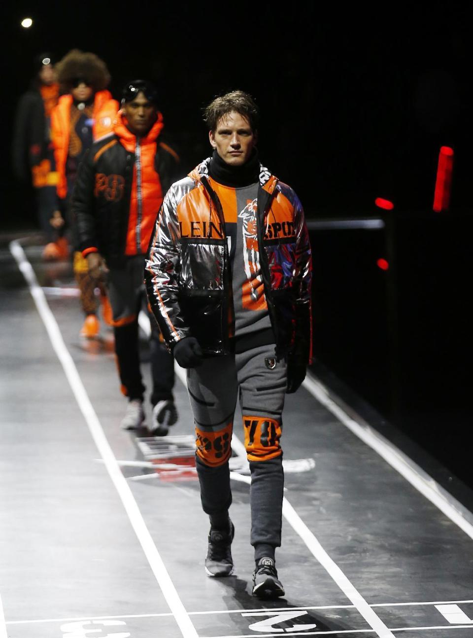 Models wear creations for Plein Sport men's Fall-Winter 2017-2018 collection, part of the Milan Fashion Week, unveiled in Milan, Italy, Saturday, Jan. 14, 2017. (AP Photo/Antonio Calanni)