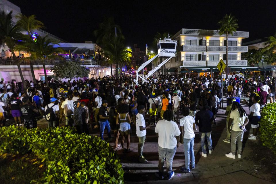 Crowds gather during spring break on Saturday, March 18, 2023, in Miami Beach, Fla. Miami Beach officials imposed a curfew beginning Sunday night, March 19, after two fatal shootings and rowdy, chaotic crowds that police have had difficulty controlling. (D.A. Varela/Miami Herald via AP)