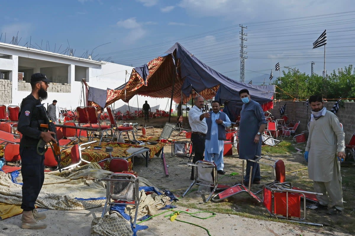 Security personnel examine the site of a bomb blast in Bajaur district (AFP via Getty Images)