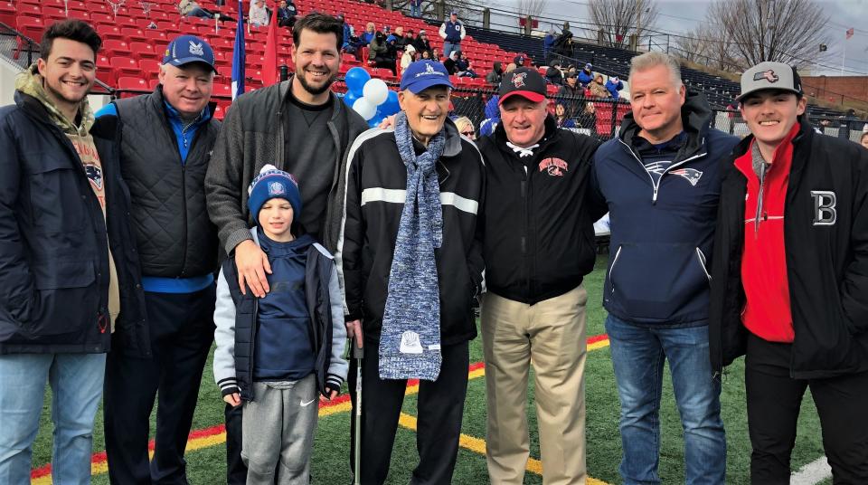 Lloyd Hill Sr. with family and friends in 2019 at Veterans Memorial Stadium in Quincy. From left, grandson Laurence, son Lloyd Jr., son Rich with grandson Brice, Lloyd Hill Sr., former North Quincy head coach Ken McPhee, son Larry and grandson Lloyd.