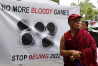 Tibetan monk Golog Jigme stands in front of a banner outside the Beijing 2022 Winter Olympic Candidate City presentation at the Palace hotel in Lausanne, Switzerland in this June 10, 2015 file photo. REUTERS/Ruben Sprich/Files