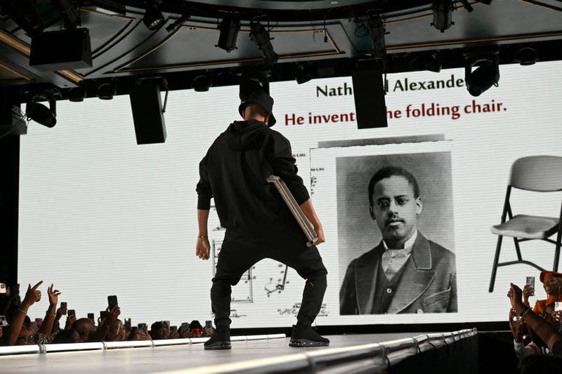 NEW YORK, NEW YORK - SEPTEMBER 08: Affion Crockett carries a folding chair - a recall to the viral meme of a folding chair wielding man who aided an Alabama dock worker who was attacked in a massive brawl - at the Actively Black fashion brand’s The Black Mixtape 2 runway show at Sony Hall on September 08, 2023 in New York City.