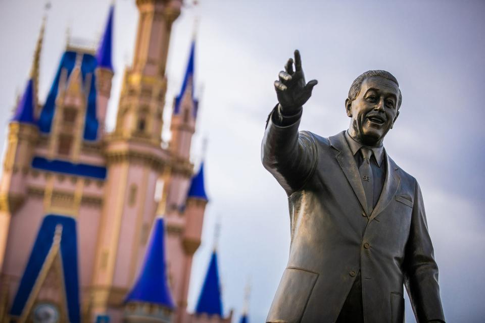 The Cinderella Castle and Walt Disney's statue inside Magic Kingdom Park at Walt Disney World resort.