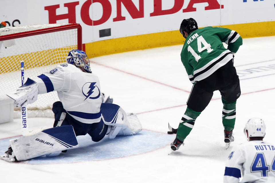 FILE - In this Jan. 27, 2020, file photo, Dallas Stars left wing Jamie Benn, right, backhandsa shot past Tampa Bay Lightning goaltender Andrei Vasilevskiy, left, for a goal during the third period of an NHL hockey game in Dallas. Two of the southernmost teams in the NHL are meeting in the Stanley Cup Final in the great white north. The Stars and the Lightning are facing off in the bubble in Edmonton, Alberta, starting with Game 1 Saturday. (AP Photo/Ray Carlin, File)