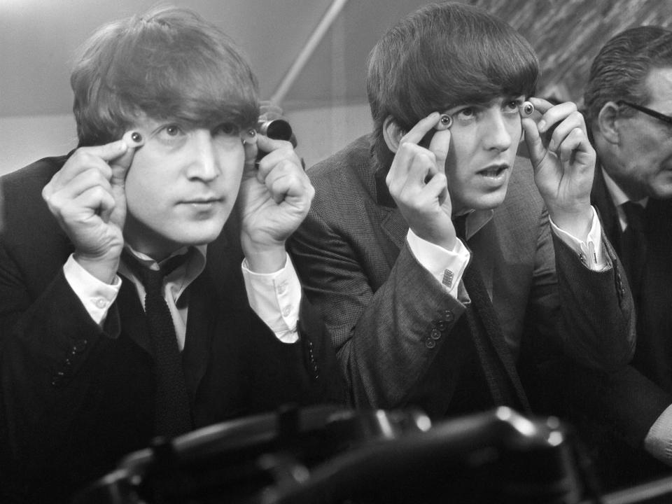 John Lennon and George Harrison with glass eyes when the Beatles' details were being taken for their Madame Tussauds waxworks during the making of "A Hard Day's Night", Twickenham Film Studios, 12 March 1964.