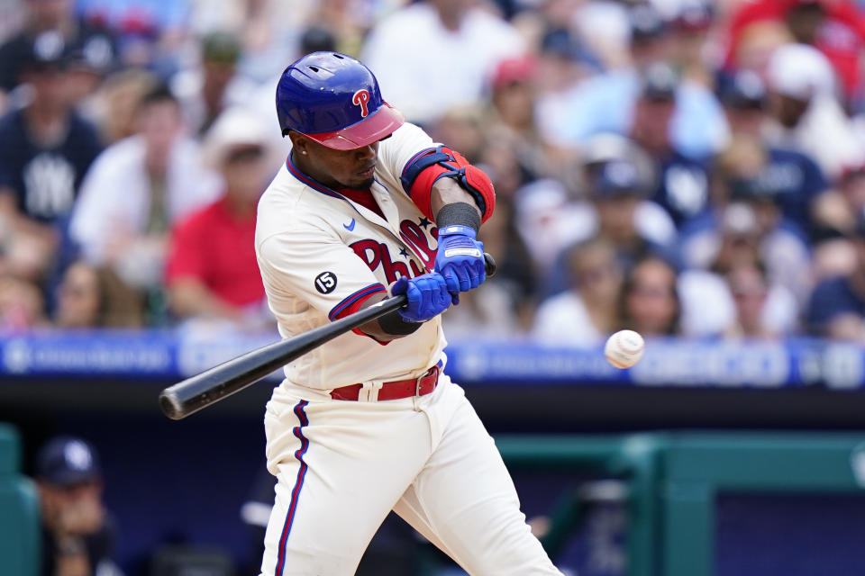 Philadelphia Phillies' Jean Segura hits a two-run single off New York Yankees pitcher Domingo German during the second inning of a baseball game, Sunday, June 13, 2021, in Philadelphia. (AP Photo/Matt Slocum)