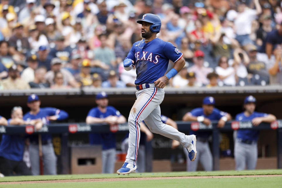 Texas Rangers' Ezequiel Duran heads home to score on a throwing error by San Diego Padres' Blake Snell in the fourth inning of a baseball game Sunday, July 30, 2023, in San Diego. (AP Photo/Derrick Tuskan)