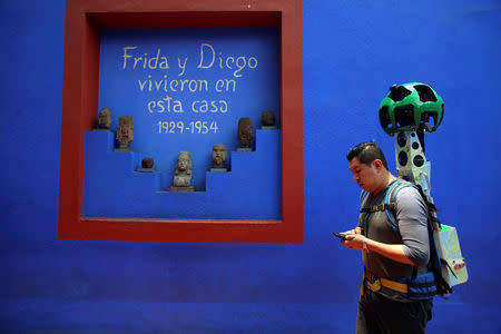 A Google employee maps the exterior of the childhood home of Mexican artist Frida Kahlo, now Frida Kahlo Museum, also known as "Casa Azul", in Mexico City, Mexico May 21, 2018. Picture taken May 21, 2018. REUTERS/Gustavo Graf