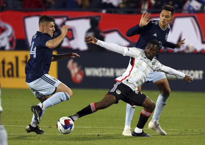 Dallas forward Tsiki Ntsabeleng (16) tries to get the ball away from Sporting Kansas City midfielder Rémi Walter (54) in the second half of an MLS soccer match, Saturday, March 18, 2023, in Frisco, Texas. (AP Photo/Richard W. Rodriguez)