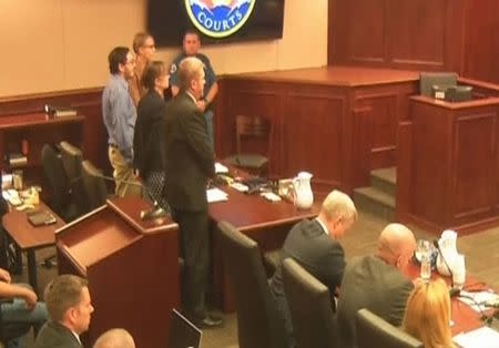 James Holmes (L) stands in court as the verdict is read in this still image taken from video in Denver, Colorado, July 16, 2015. REUTERS/Pool