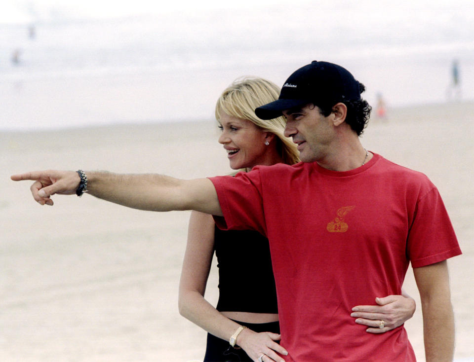 Spain's international actor Antonio Banderas (R) makes a point to his American wife Melanie Griffith as they pose for photographers at San Sebastian's Zurriola beach September 17, 1999. Banderas'first film "Crazy in Alabama" will compete in San Sebastian's International Film Festival. REUTERS/Pablo Sanchez