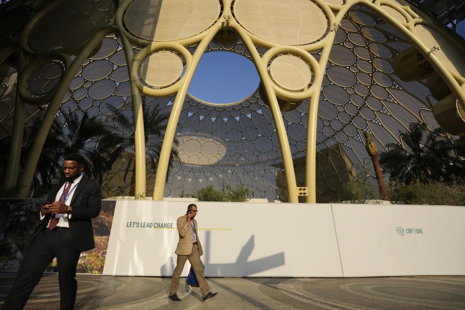 People walk near Al Wasl Dome at Expo City at the COP28 U.N. Climate Summit, Saturday, Dec. 2, 2023, in Dubai, United Arab Emirates. (AP Photo/Rafiq Maqbool)