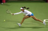 Ana Ivanovic of Serbia returns the ball to Daniela Hantuchova of Slovakia during the second day of the WTA Qatar Ladies Open in Doha, Qatar, Tuesday Feb. 11, 2014. (AP Photo/Osama Faisal)