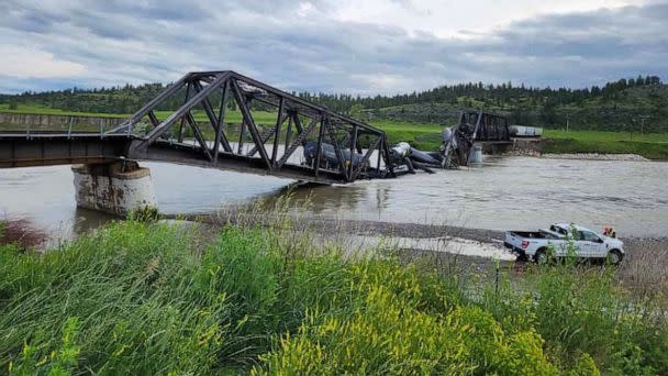 PHOTO: Several train cars are immersed in the Yellowstone River after a bridge collapse near Columbus, Mont., on June 24, 2023. (Montana Fish, Wildlife & Parks - Region 5)