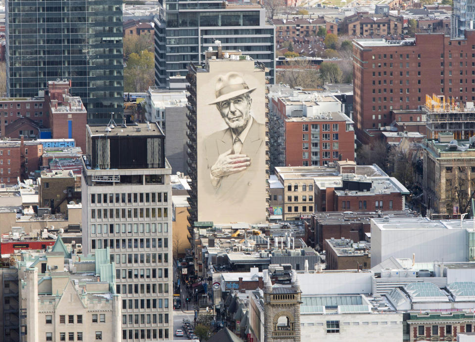 A towering mural of the late poet/songwriter Leonard Cohen is seen in downtown Montreal on Friday, Nov. 10, 2017, paying tribute to the city’s native son just over a year after his death. He spent the latter decades of his life back in the city whose vibe and famous sites infused his work. (Ryan Remiorz/The Canadian Press via AP)