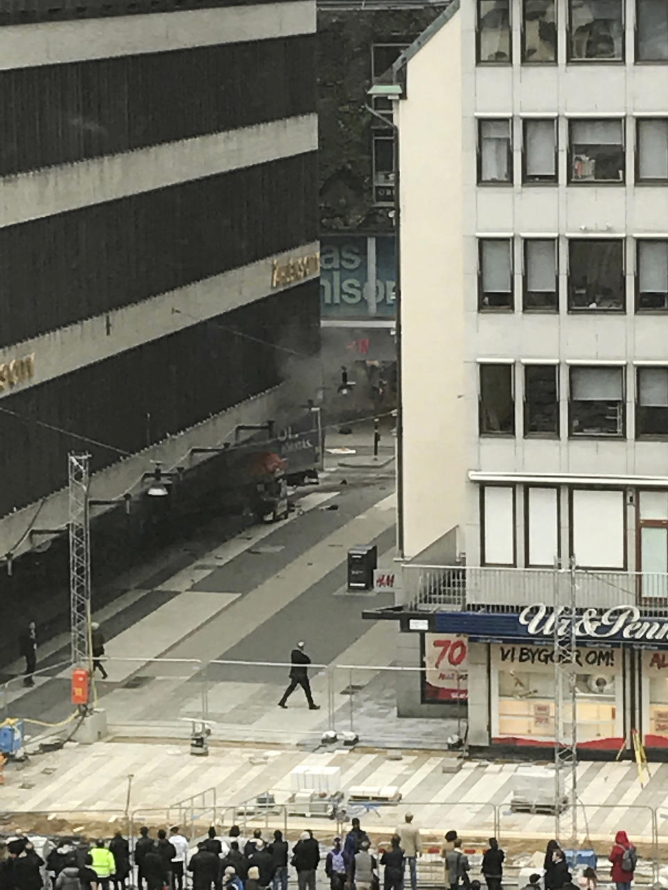 People look on at the scene after a truck crashed into a department store injuring several people in central Stockholm, Sweden, Friday April 7, 2017. (Andreas Schyman, TT News Agency via AP)