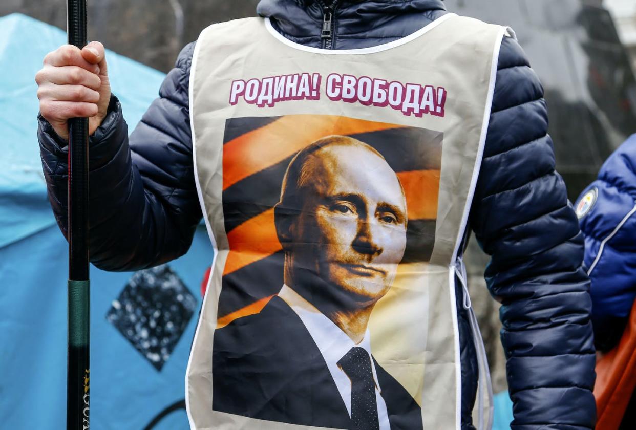 <span class="caption">A pro-Russia demonstrator wears a vest bearing a depiction of Russian President <span class="caas-xray-inline-tooltip"><span class="caas-xray-inline caas-xray-entity caas-xray-pill rapid-nonanchor-lt" data-entity-id="Vladimir_Putin" data-ylk="cid:Vladimir_Putin;pos:1;elmt:wiki;sec:pill-inline-entity;elm:pill-inline-text;itc:1;cat:OfficeHolder;" tabindex="0" aria-haspopup="dialog"><a href="https://search.yahoo.com/search?p=Vladimir%20Putin" data-i13n="cid:Vladimir_Putin;pos:1;elmt:wiki;sec:pill-inline-entity;elm:pill-inline-text;itc:1;cat:OfficeHolder;" tabindex="-1" data-ylk="slk:Vladimir Putin;cid:Vladimir_Putin;pos:1;elmt:wiki;sec:pill-inline-entity;elm:pill-inline-text;itc:1;cat:OfficeHolder;" class="link ">Vladimir Putin</a></span></span> and the words "Motherland! Freedom!" during a rally in Donetsk, Ukraine, in 2014.</span> <span class="attribution"><a class="link " href="https://newsroom.ap.org/detail/AnalysisUkraineTensionsPutinSpeech/98014b57a6204e4ab4039e0dfa58c5d0/photo?Query=putin&mediaType=photo&sortBy=arrivaldatetime:desc&dateRange=Anytime&totalCount=41150&currentItemNo=511" rel="nofollow noopener" target="_blank" data-ylk="slk:AP Photo/Andrey Basevich;elm:context_link;itc:0;sec:content-canvas">AP Photo/Andrey Basevich</a></span>