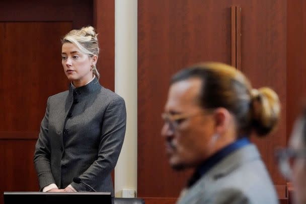 PHOTO: Actors Amber Heard and Johnny Depp watch as the jury leave the courtroom for a lunch break at the Fairfax County Circuit Courthouse in Fairfax, Va., May 16, 2022. (Steve Helber/Pool via Reuters)